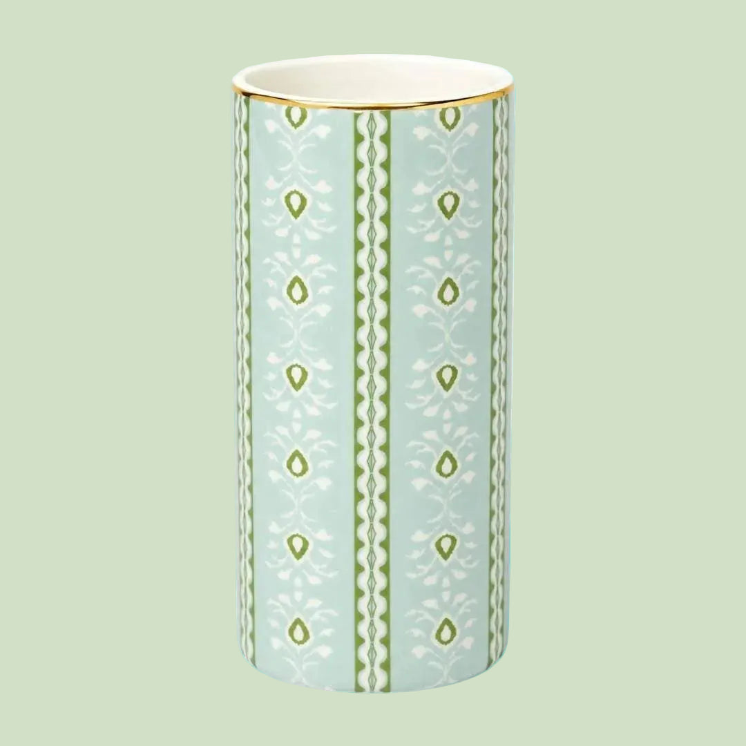 Laura Park Decorative vase with green pattern on a light blue background
