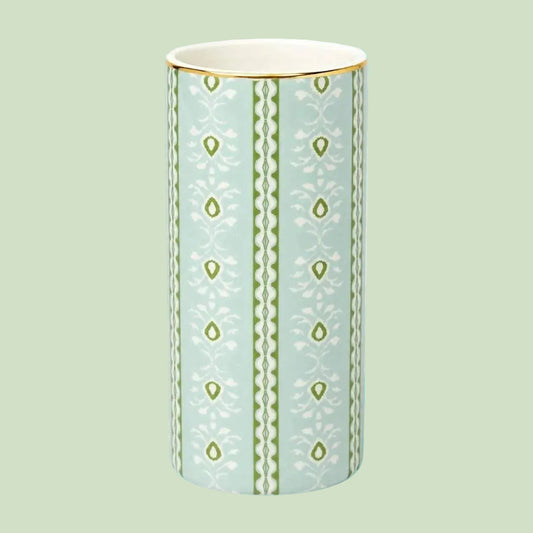 Laura Park Decorative vase with green pattern on a light blue background